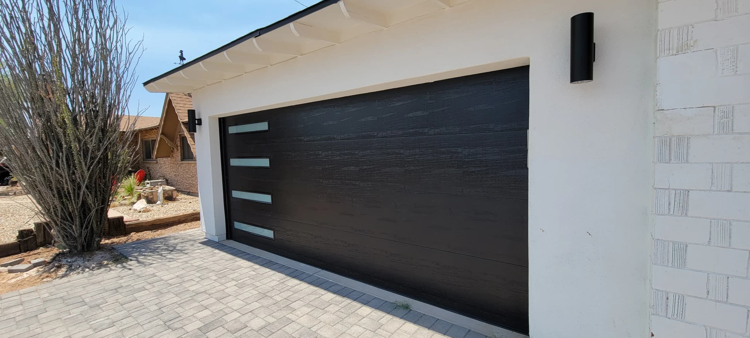 A modern textured black garage door highlighting the importance of garage door services