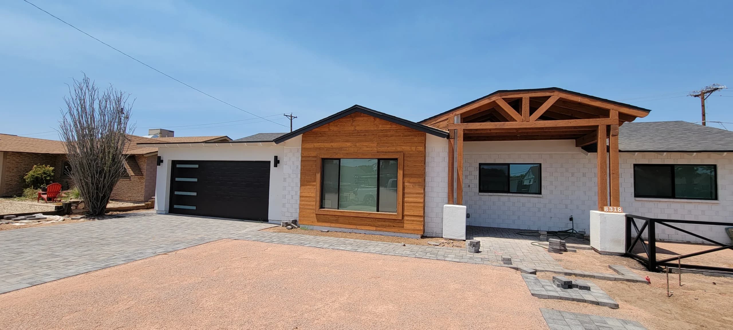 A modern residential home with a sleek black door installed by reliable garage door services in Chandler