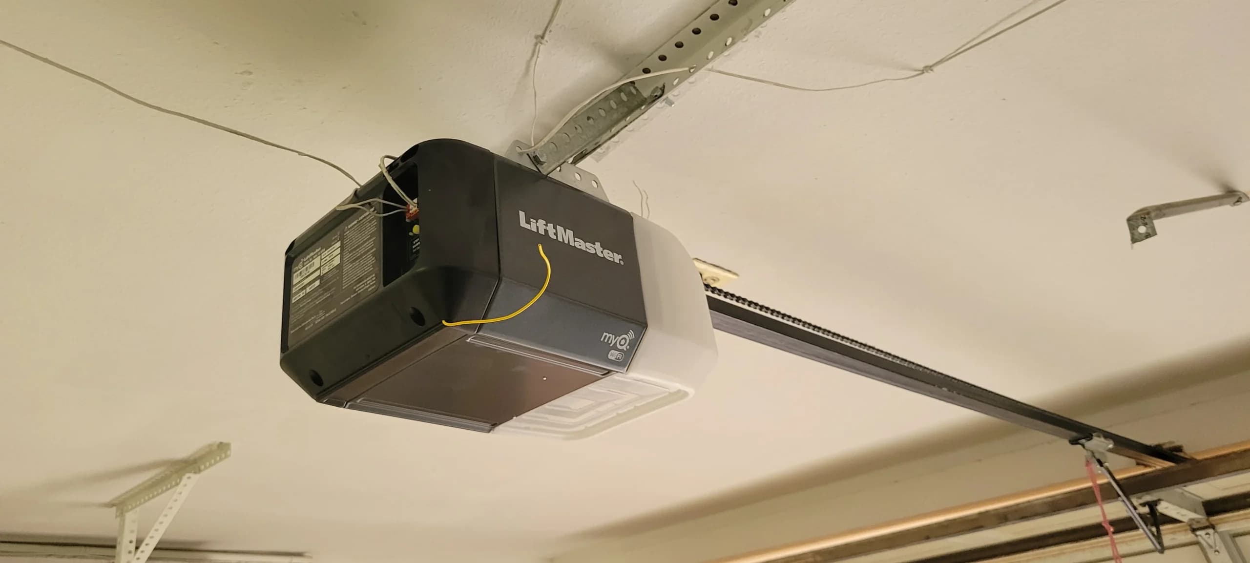 A wall-mounted LiftMaster unit showing what do LiftMaster beeping sounds actually mean during operation.