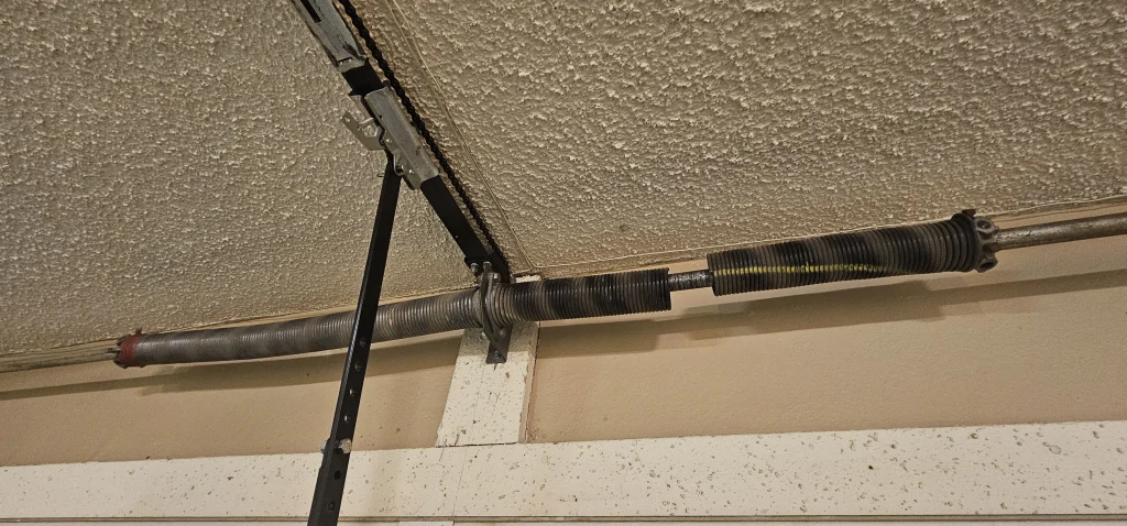 An overhead view of a dual garage door torsion spring assembly
